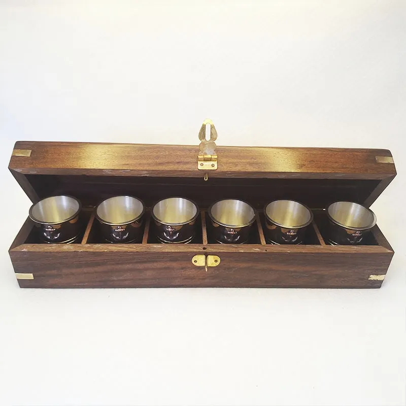 Bronze shot glasses in a wooden box