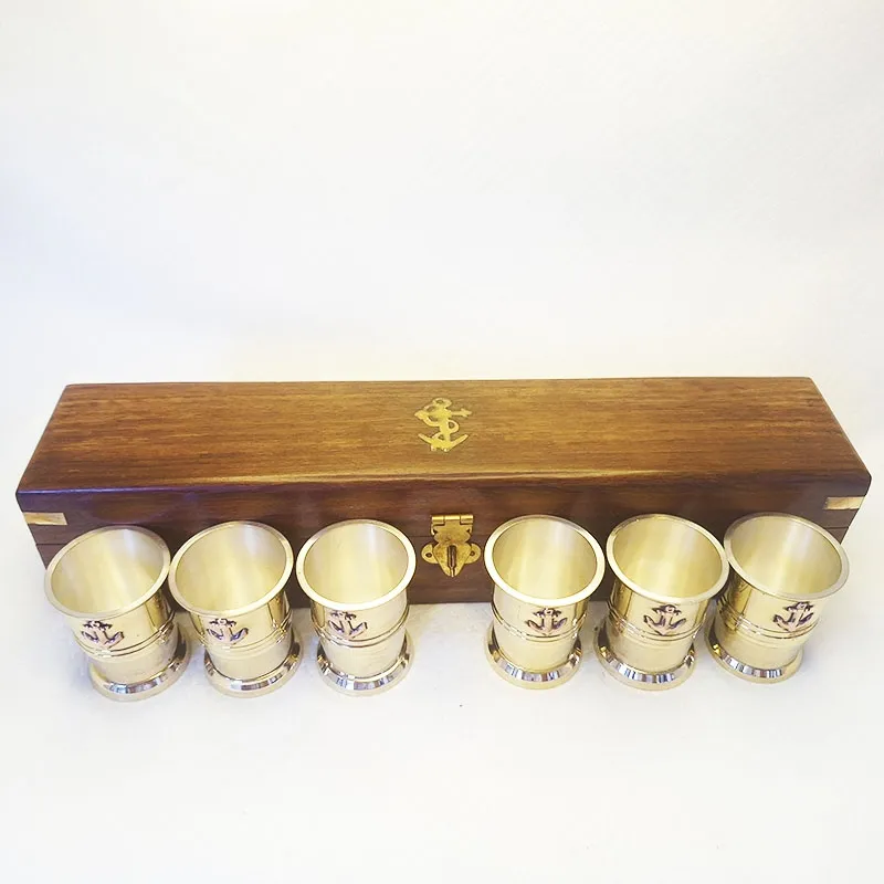 Bronze shot glasses in a wooden box