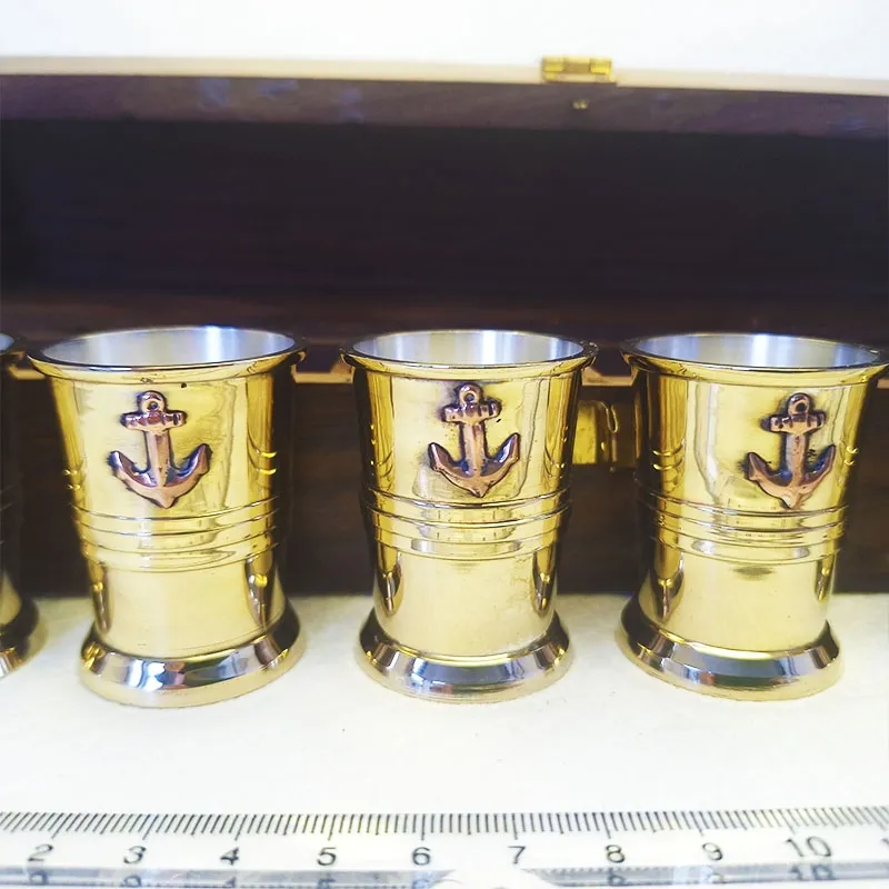 Bronze shot glasses in a wooden box